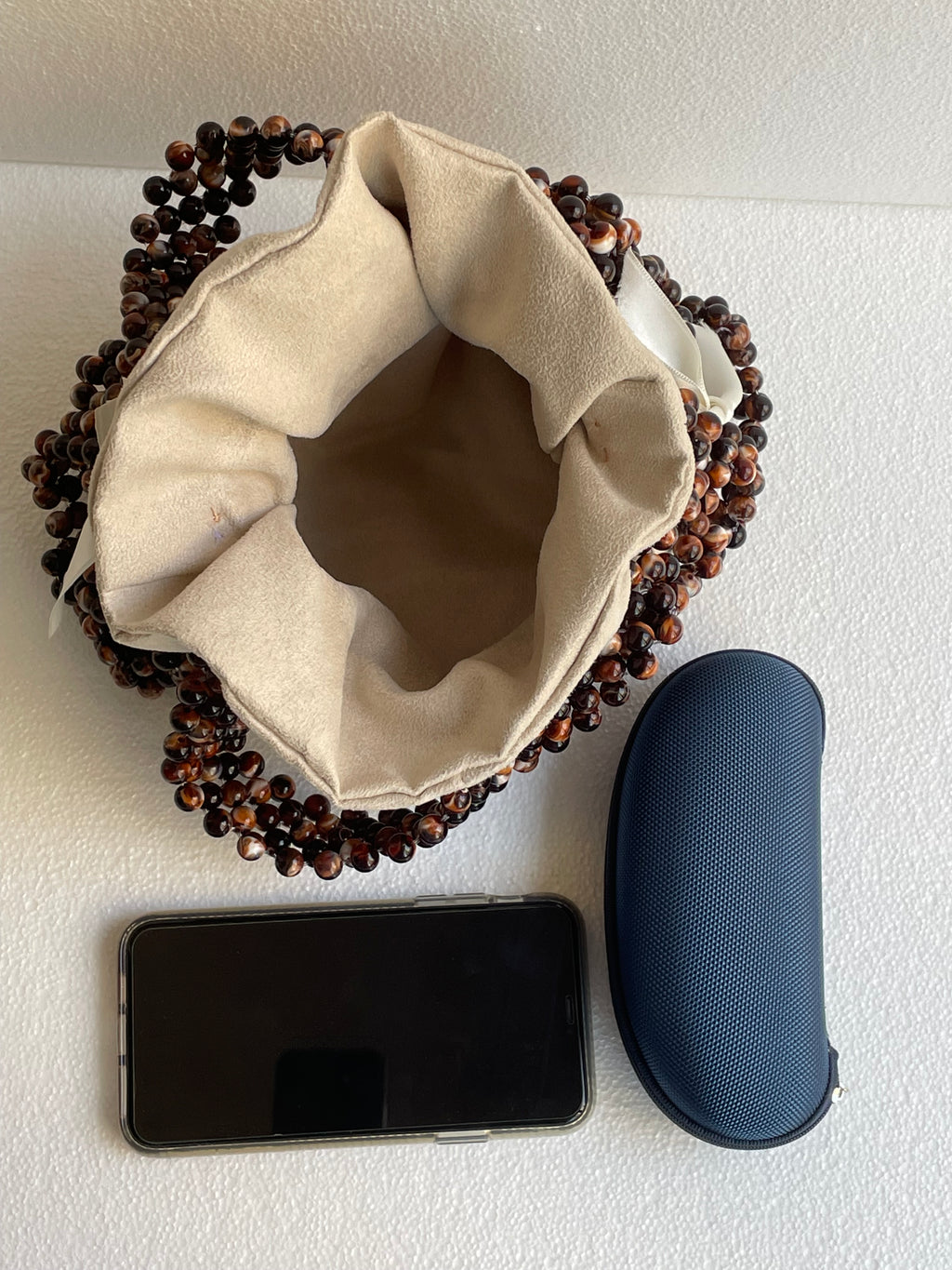Bassmera Noisette beaded bag interior capacity – fits a phone and sunglasses case

