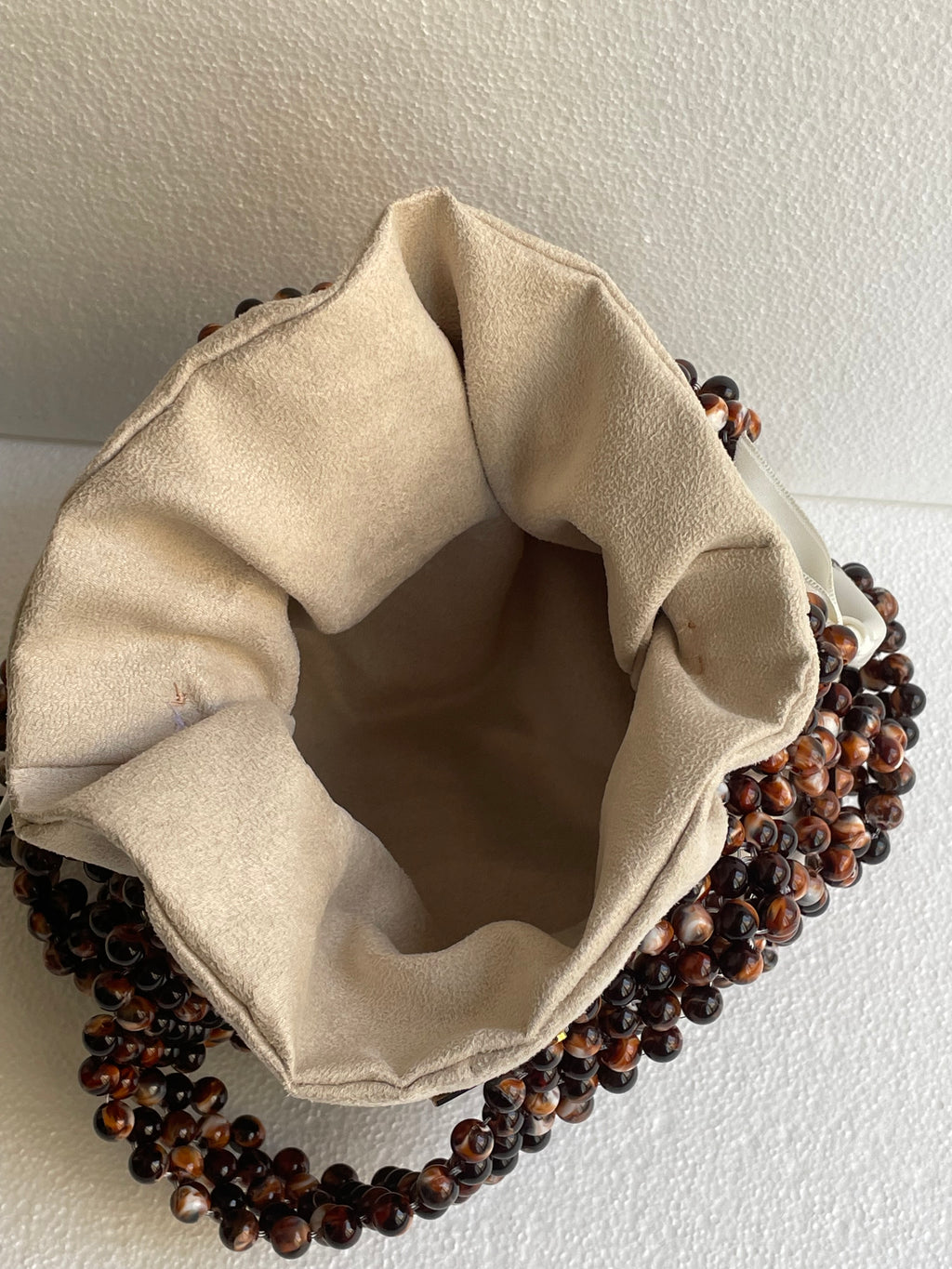 Bassmera Noisette beaded bag – spacious soft suede interior view, open top